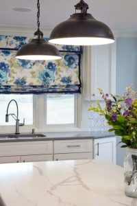 Beautiful kitchen sink with blue floral curtain