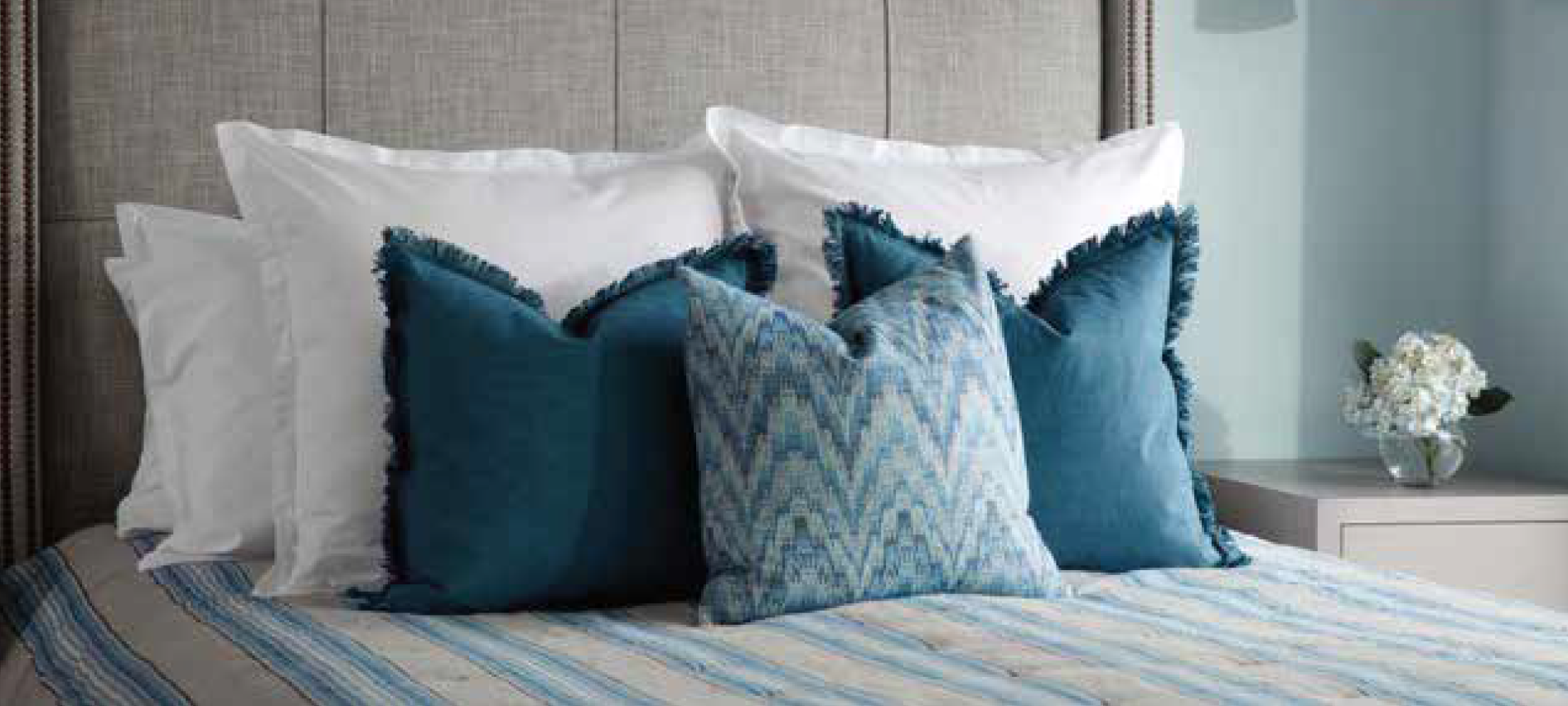 Blue and White Pillows on a bed